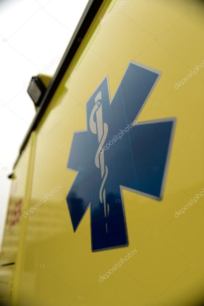 Blue star paramedics symbol on yellow ambulance car