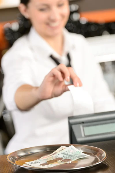 Young cashier giving receipt czech crowns — Stock Photo, Image
