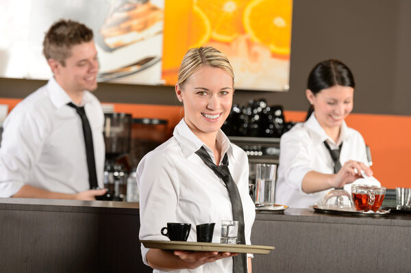 Confident waitress serving coffee with tray