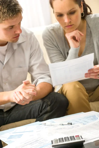 Troubled couple calculating finances — Stock Photo, Image