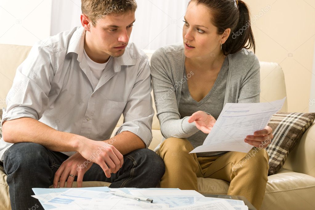 Worried couple talking about their expenses