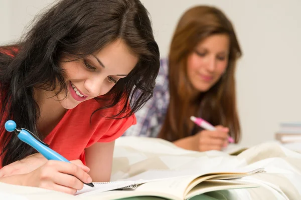 Young teenager girls studying on bed — Stock Photo, Image