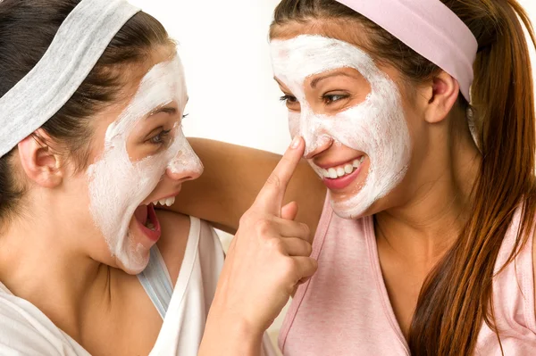 Playful teen wearing mask touches friend's nose — Stock Photo, Image