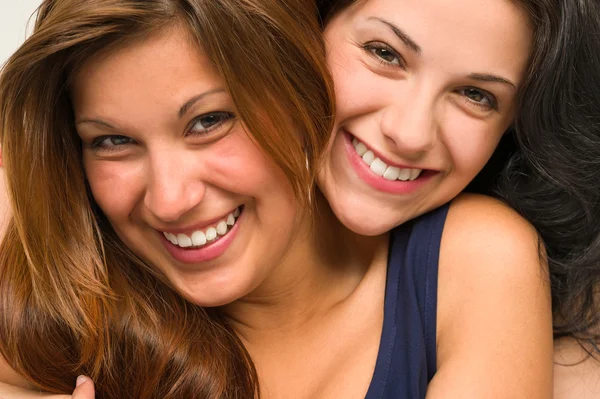 Close up portrait of beautiful girls hugging Royalty Free Stock Photos