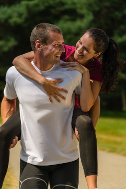 gülümseyen adam kız arkadaşı atçılık vererek