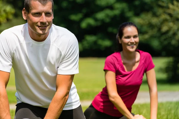 Close up portrait of couple stretching outdoors — Stock Photo, Image