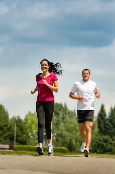 Couple friends running a race in park — Stock Photo, Image