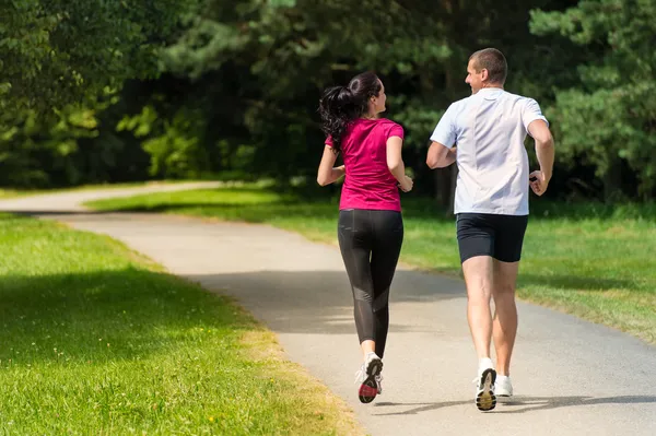 Rear view of caucasian runners outdoors Stock Image