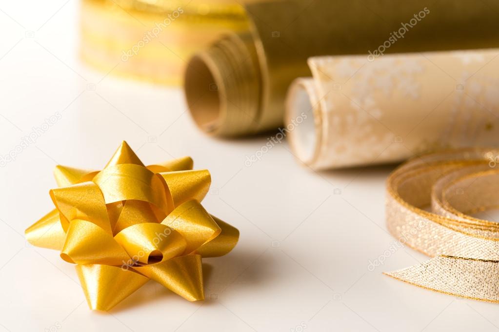 Golden wrapping paper and bow present decoration