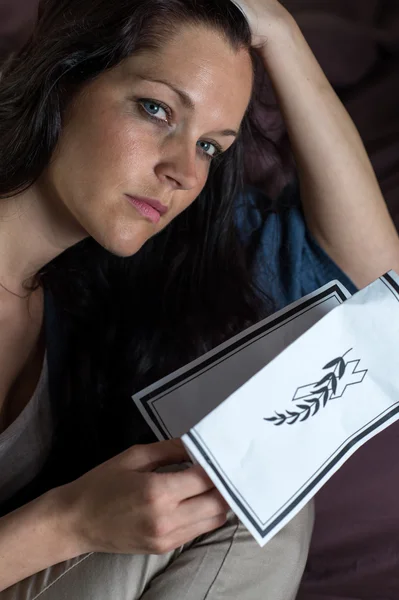 Portrait of young widow holding obituary — Stock Photo, Image