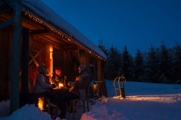 Evening winter cottage friends enjoy hot drinks — Stock Photo, Image