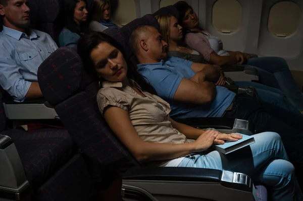 Flight passengers sleep plane cabin night travel — Stock Photo, Image