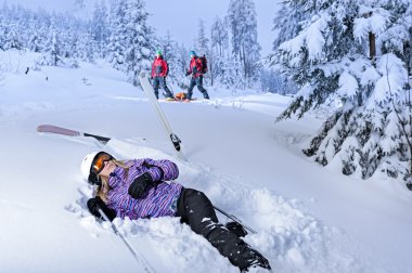 Injured skier after accident waiting for rescue clipart