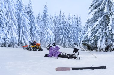 Injured skier after accident waiting for rescue clipart