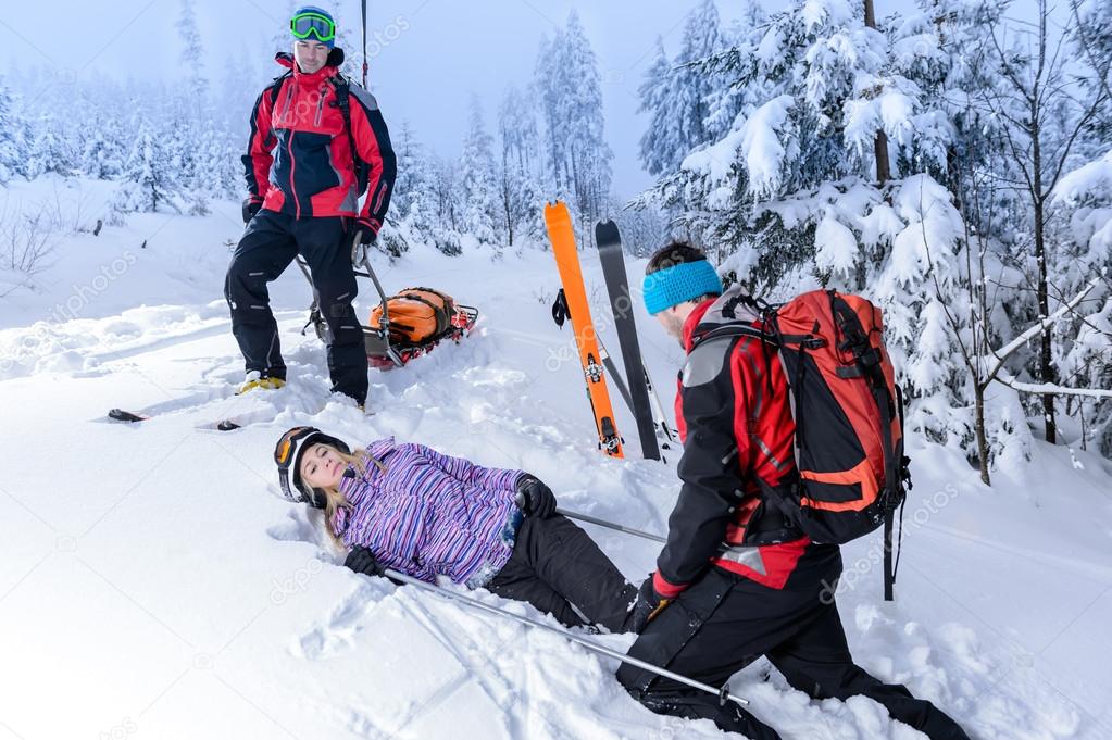 Rescue ski patrol help injured woman skier