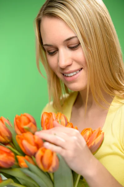 Woman looking down spring flowers orange tulips — Stock Photo, Image