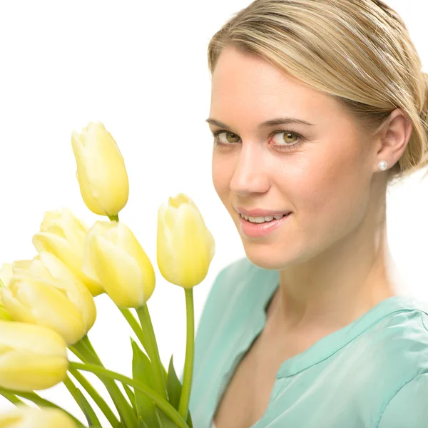 Blond woman with yellow tulips spring flowers — Stock Photo, Image