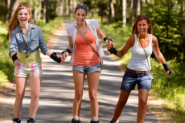 Jovens mulheres alegres em patins ao ar livre — Fotografia de Stock