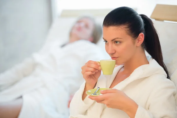 Woman drinking coffee at spa — Stock Photo, Image