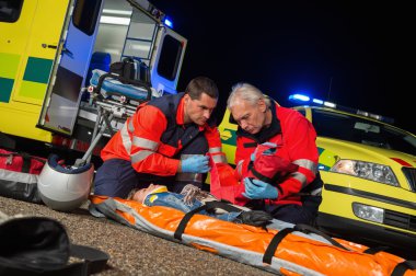 Motosiklet sürücüsü için FirstAid veren sağlık görevlileri