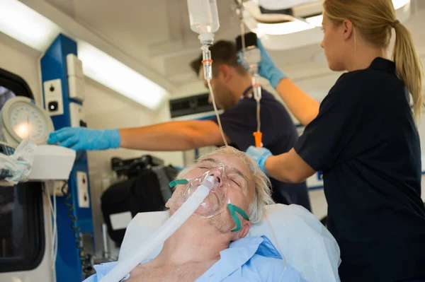 Patient with oxygen mask in ambulance — Stock Photo, Image