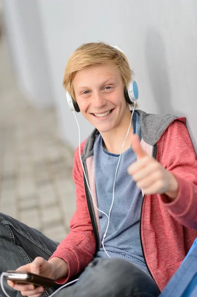 Teenage student thumb-up listen to music — Stock Photo, Image