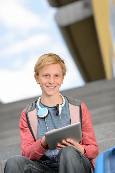 Boy using tablet on steps — Stock Photo, Image