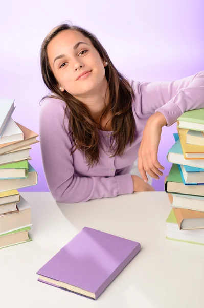 Girl between stacks of books — Stock Photo, Image