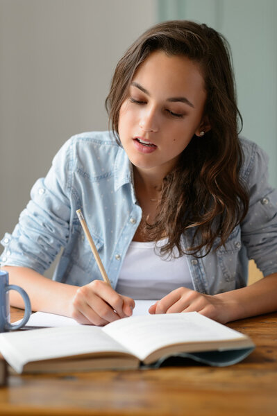 Teenage girl writing notes