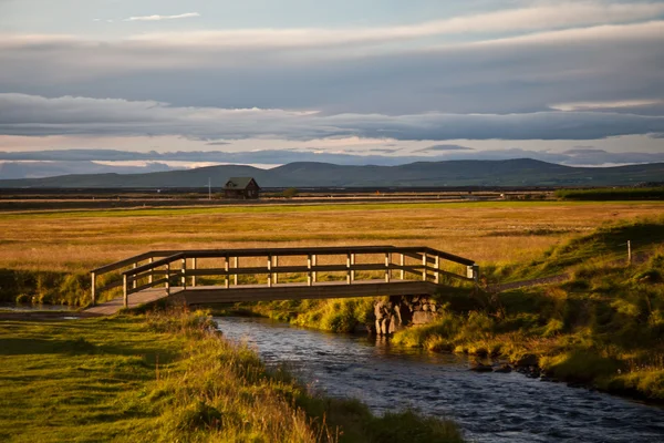 Wooden bridge over a small river in Iceland Stock Photo