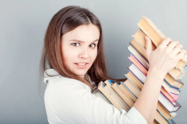 Girl holding stack of  book — Stock Photo, Image