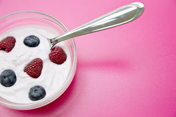 Glass bowl with jogurt and spoon in — Stock Photo, Image