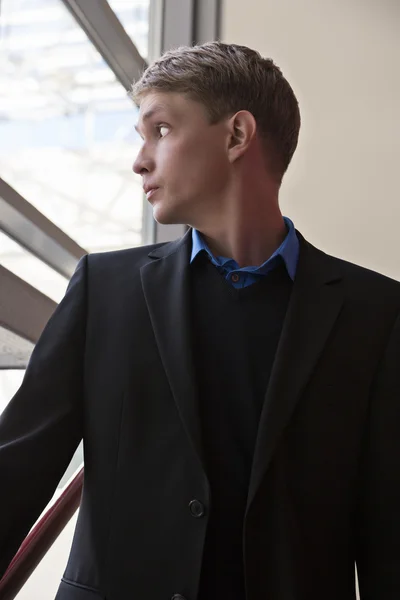 Businessman watching window and wonder about weather — Stock Photo, Image