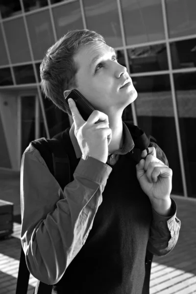 Shaded teacher speaking by telephone with someone