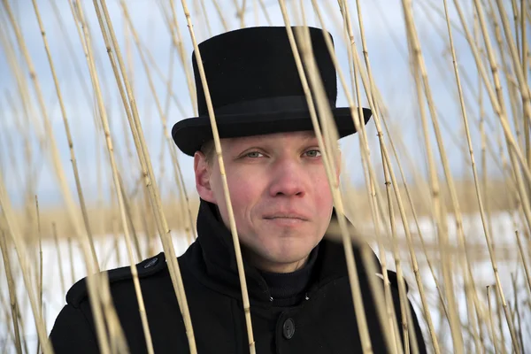 Young man looking through reed brush — Stock Photo, Image