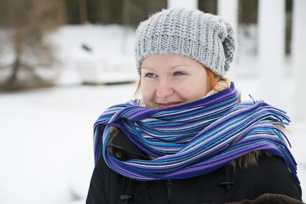 Wrapped in scarf woman looking at distance — Stock Photo, Image