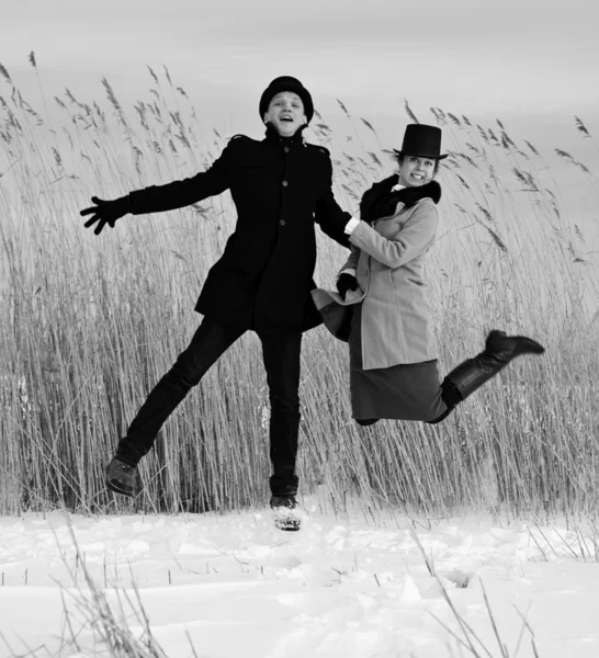 Shaded man and woman jump on lake — Stock Photo, Image