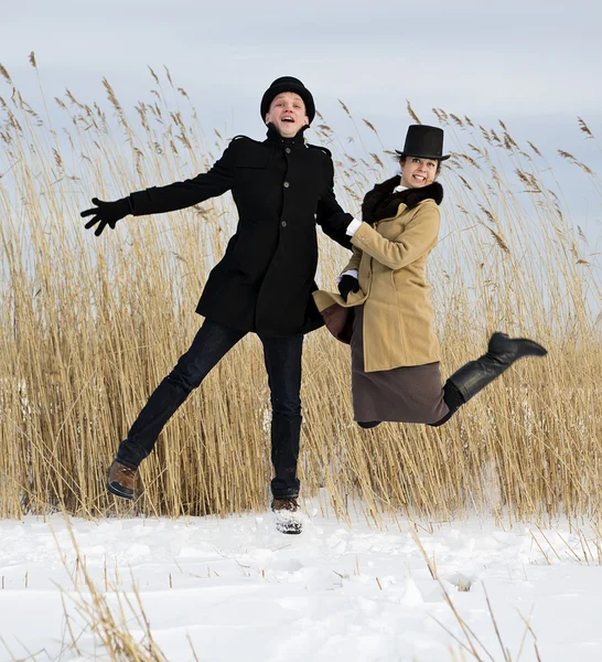 Man and woman jump on lake beach — Stock Photo, Image