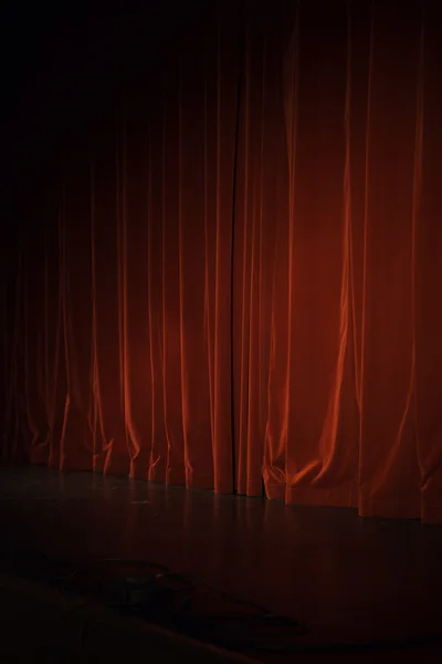 Lighted down red stage curtain — Stock Photo, Image