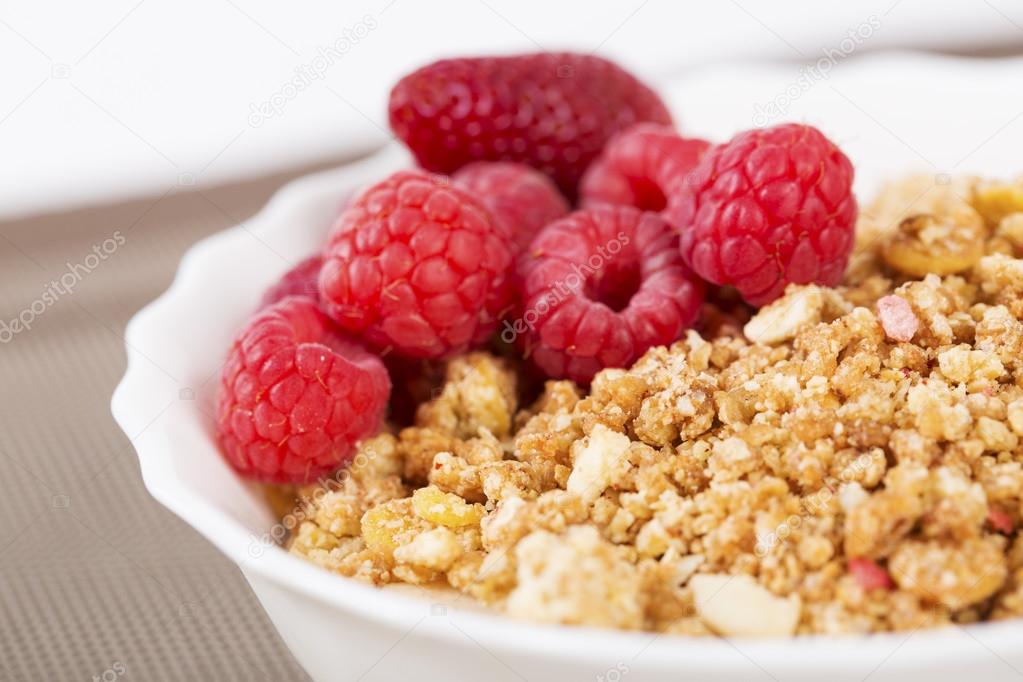Zoomed berries on golden cereals in bowl