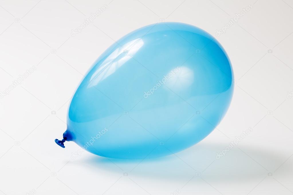 Blue balloon with helium on studio ground