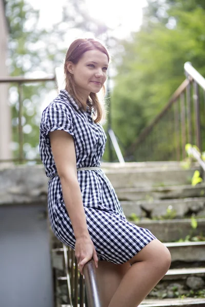 Woman in dress sit on ladder boundaries — Stock Photo, Image