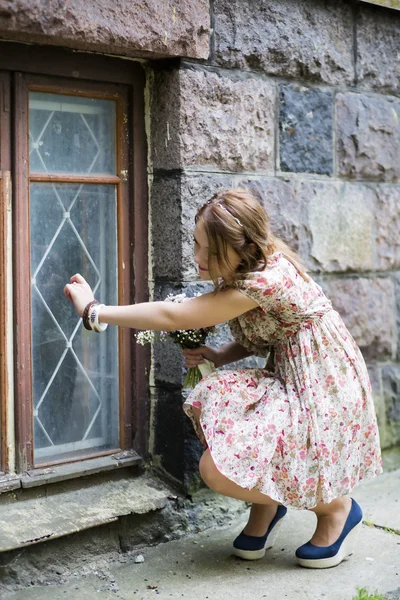 Woman in dress knocking on window glass — Stock Photo, Image