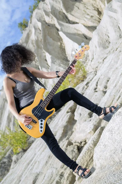 Visão angular da mulher com guitarra baixo — Fotografia de Stock