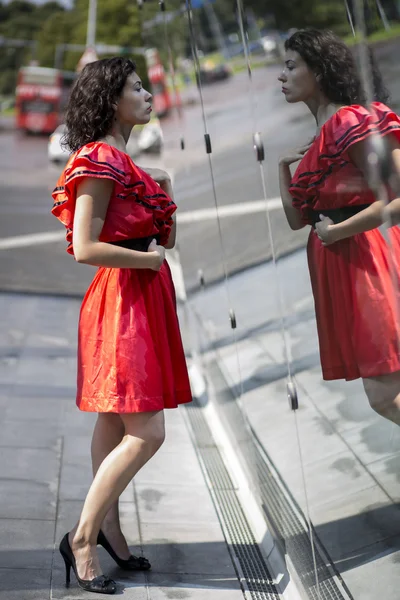 Woman in red dress adjust herself — Stock Photo, Image