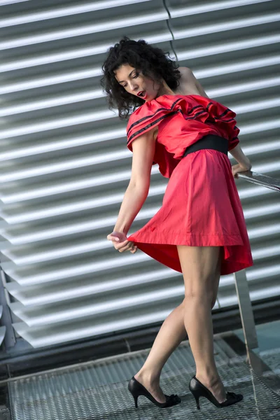 Woman in nice dress stretches her skirt — Stock Photo, Image