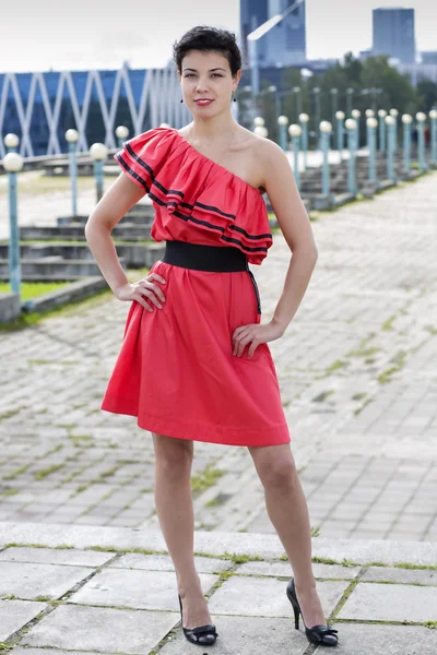 Woman in nice red dress stand — Stock Photo, Image