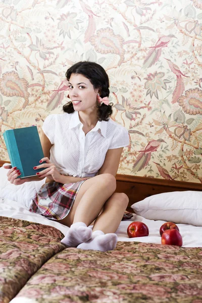 Woman in schoolgirl dress with mysterious book — Stock Photo, Image