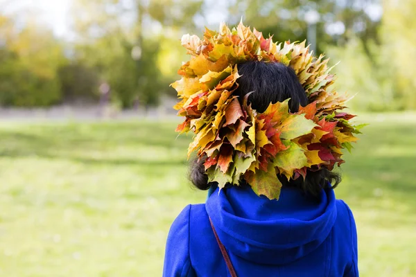 Woman with maple leaves on head — Stock Photo, Image