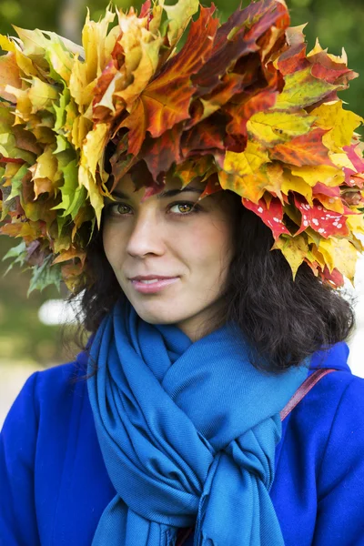 Woman with leaves on head with scarf — Stock Photo, Image